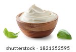 wooden bowl of whipped sour cream yogurt isolated on white background