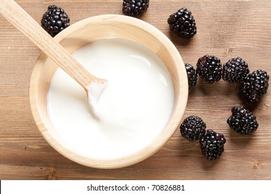 Wooden Bowl With Yogurt And Blackberries