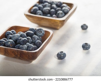 Wooden Bowls With Fresh Blueberries On A White Background. Delicious Vitamin Product, Ready To Use. Cooking. Recipe Book, Food Blog. There Are No People In The Photo.