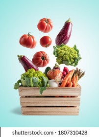 Wooden Box With Flying Vegetables, On Blue Background