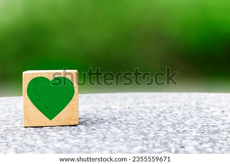 wooden box with a heart icon .Doing business with consideration for environment and nature