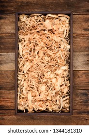 Wooden Box With Shavings Straw Filling On Table. Wine Bottle Crate. Top View.