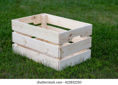 wooden box from solid pine standing on the green grass