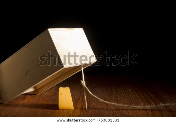 Wooden box as a trap\
on a black background