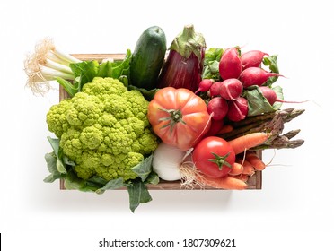 Wooden box with vegetables isolated from the white background, top view