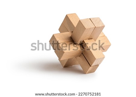 Wooden brain teaser. Close-up view of assembled burr puzzle isolated on white background