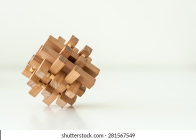 Wooden Brain Teaser On White Background. Logic Game