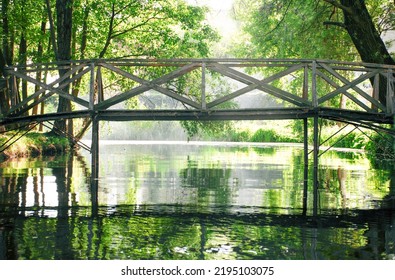 wooden bridge across the river in the sun. romantic place for a date