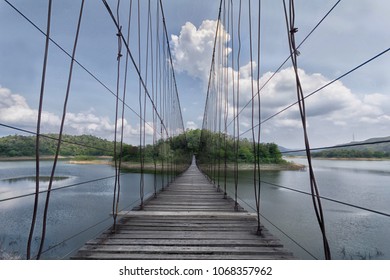 A wooden bridge crosses a small island.