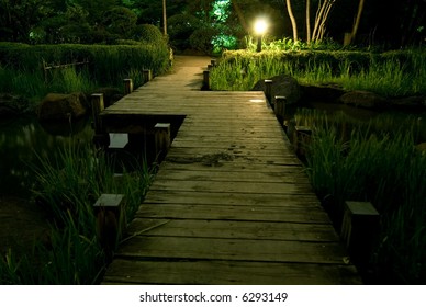 Wooden Bridge In Japanese Garden At Night