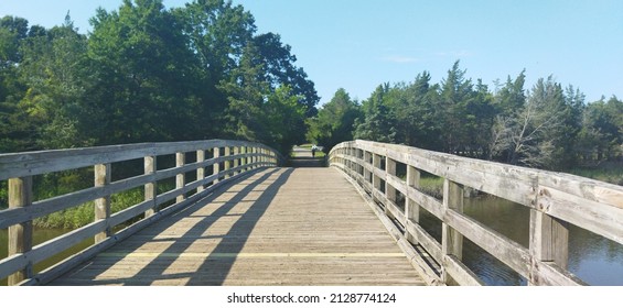 Wooden Bridge Leading To Hidden Path