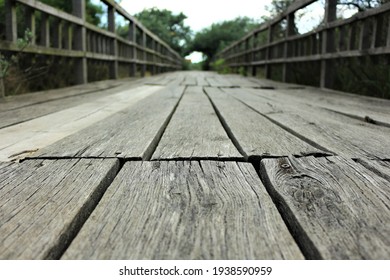 A Wooden Bridge Observed From A Ground Level Perspective