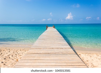Wooden bridge on the tropical beach and blue sky summer background - Powered by Shutterstock