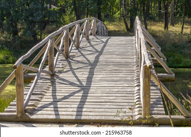 Wooden bridge over forest pond