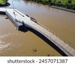 wooden bridge over the Parana river in San Nicolas de los Arroyos brown water