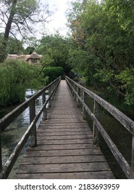 Wooden Bridge Over River Scene