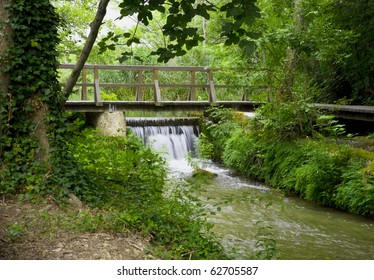 wooden bridge over a small waterfall