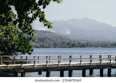 The wooden bridge that functions as a dock for small boats and also a photo spot for tourists to see the sunset is located at Cassabonely Resto and Cafe in Wairterang, Maumere, Flores, Indonesia