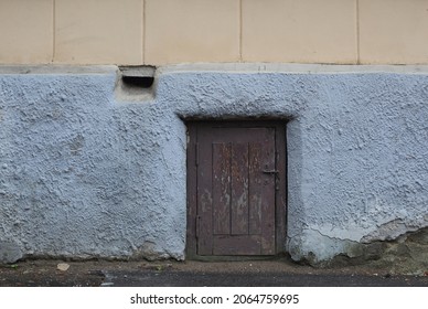 Wooden Brown Garbage Chute Door In The Stone Wall