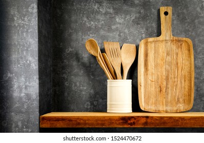 Wooden brown kitchen shelf with free space for your decoration. Gray rero wall background and dark shadows.  - Shutterstock ID 1524470672