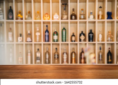 Wooden Brown Table With Blurred Liquor Bar