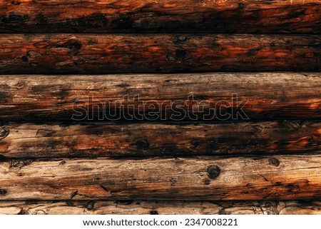 Wooden bungalow log cabin facade detail, texture of brown pine wood as background