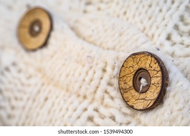 Wooden button on the knitted wool cardigan sweater