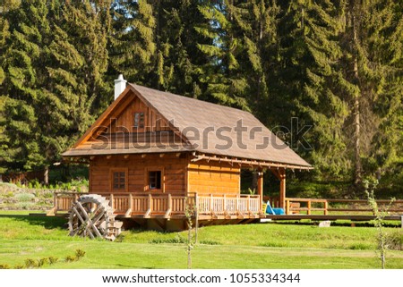 Wooden cabin in forest outdoors. Traditional wooden house.