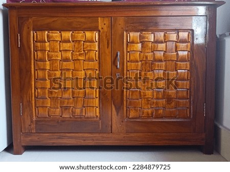 A wooden cabinet with a door 
