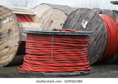 Wooden cable reels outdoors during a cold rainy day.