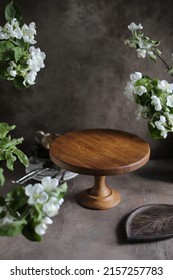 Wooden Cake Stand On The Table With Spring Apple Tree Flowers. Preparation For The Holiday.