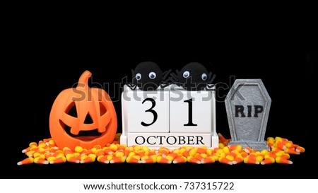 wooden calendar blocks depicting date for halloween october 31st on a black background with