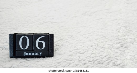 Wooden Calendar From Blocks On A White Textile Background With Copy Space. Banner. 6th Of January. Christmas Eve. Epiphany