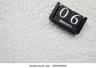 Wooden Calendar From Blocks On A White Textile Background With Copy Space. 6th Of January. Christmas Eve. Epiphany