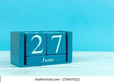 Wooden Calendar With The Date Of June 27 On A Blue Wooden Background, World Fisheries Day, World Microbiome Day