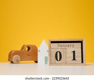 Wooden calendar made of cubes on a yellow background. Date January 1st, beginning of the year - Powered by Shutterstock