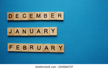 Wooden calendar of winter months December January February. Of turf cubes on a blue background. Flat styling style. Top view. - Powered by Shutterstock