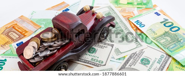 wooden car with coins on euro and dollars\
texture background\
panorama