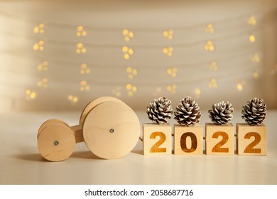 wooden car driving new year numbers 2022 and pine cones. toy car carrying wooden blocks. new year celebration and approach. Happy New year. Copy space. - Powered by Shutterstock