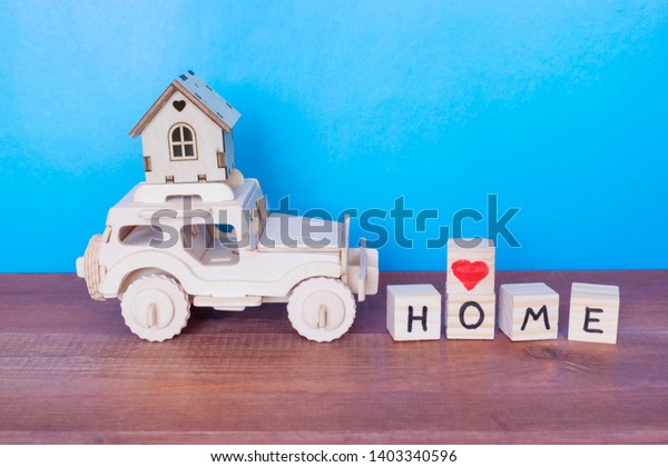 Wooden car and\
house on the blue background.\
