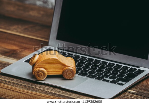 Wooden car and\
laptop