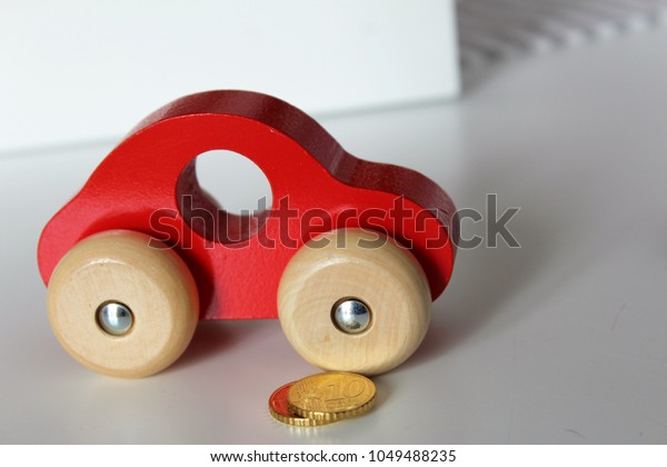 wooden car toy and\
coins.