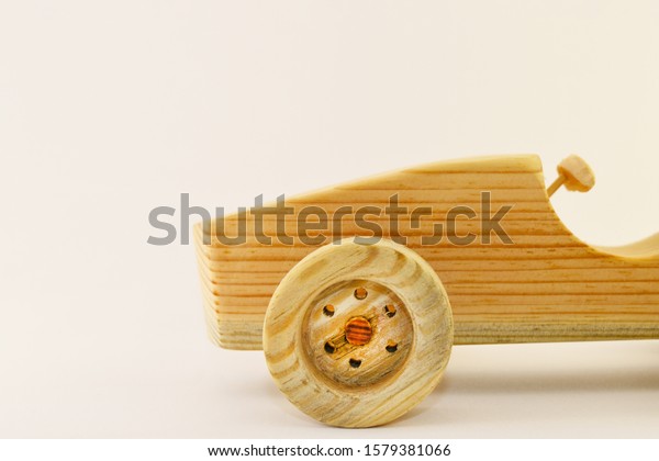 Wooden car toy, side view. Racing car in\
retro style. Toy for coloring and creative\
ideas.