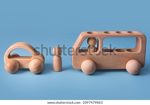 Wooden cars, baby toy for child on blue background.\
Eco friendly, plastic free toddler kids toys. Educational\
Montessori learning wooden\
toys.