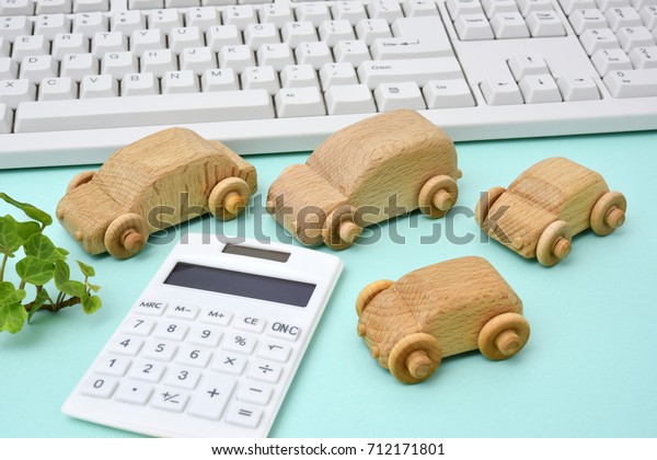Wooden cars and calculator and keyboard  - Purchase\
of cars, car selection\
image