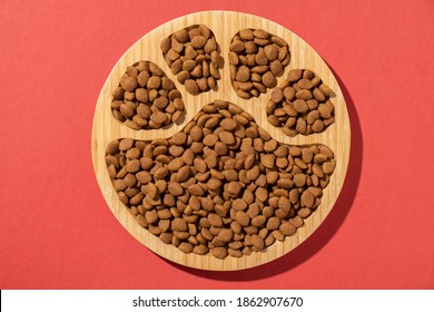 Wooden carved snack or food bowl with round paw pattern - Shutterstock ID 1862907670
