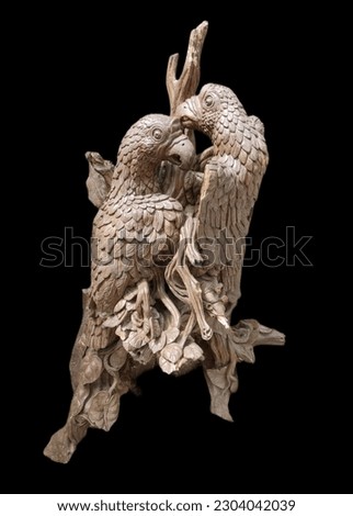 Wooden carving bird with the black background