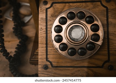 Wooden case of an old vintage rotary telephone. Retro telephones with handset. Obsolete, no longer in use phone. Nostalgic technologies.