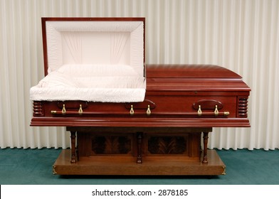 Wooden casket made of Cherry in a funeral home.
