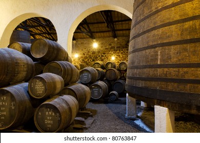 wooden casks of different sizes hold Port fortified wine to mature in wine cellars in Villa Nova de Gaia, Portugal